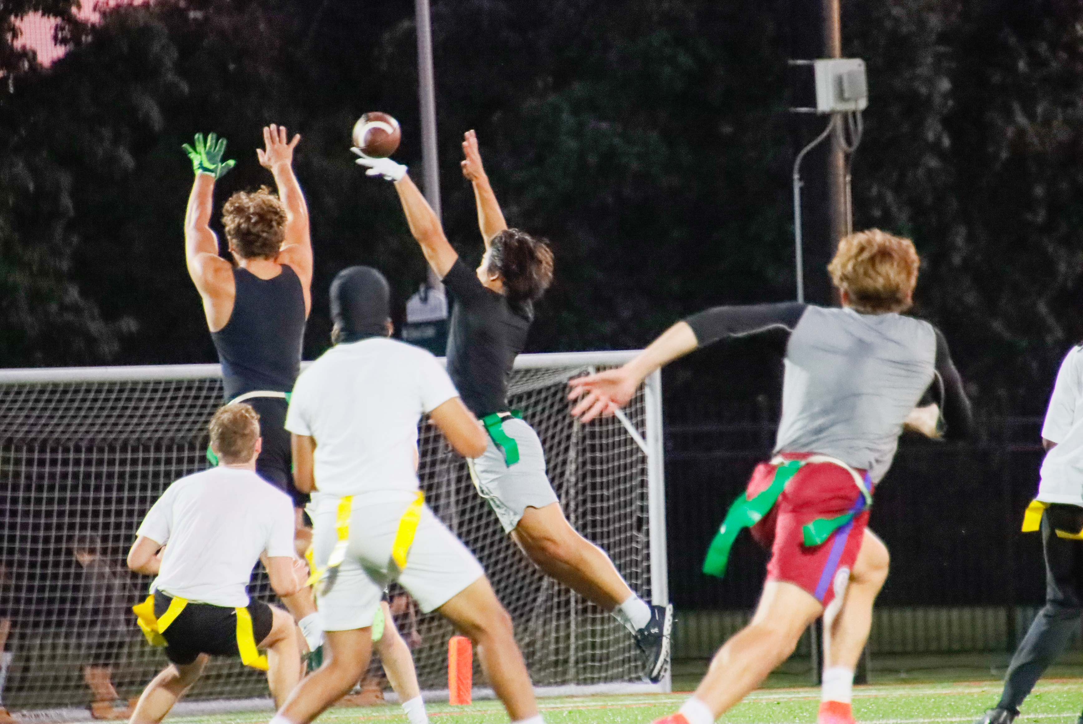 Intramural flag football on Munn Field at dusk