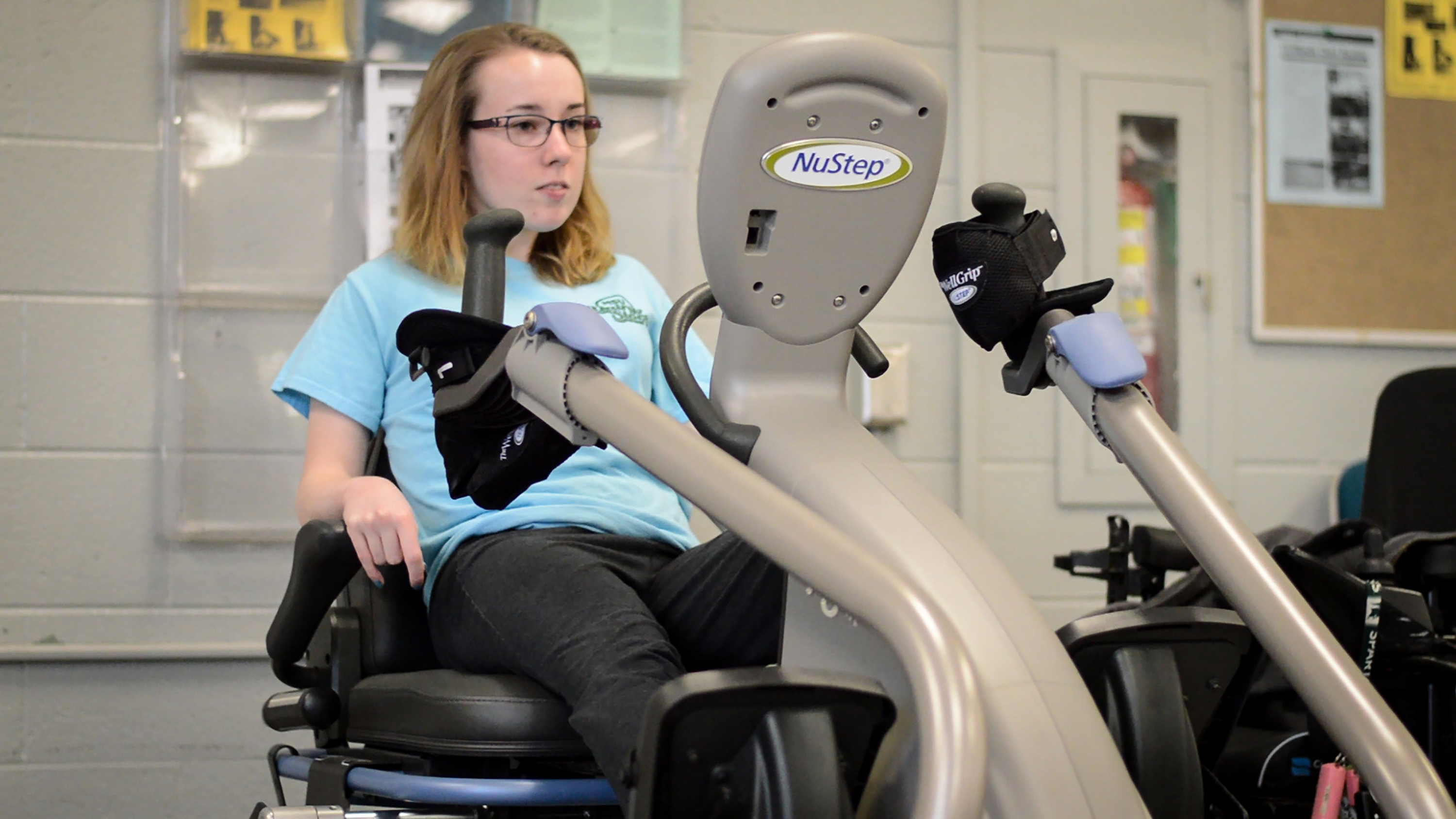 Girl using NuStep machine at IM East