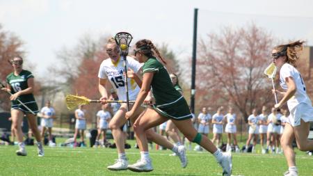 Womens Lacrosse playing on Spartan Greens